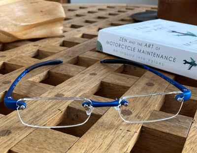 Close up of Visualites 7 half eye readers on a table with a book