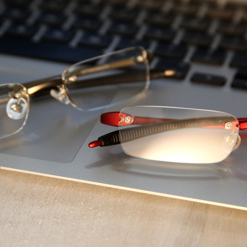 Visualites 7 half-eye rimless reading glasses sitting on a computer