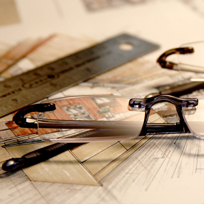 Visualites C Blue Light Filtering Computer Reading Glasses sitting on a architectural drawing