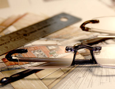 Rimless Computer Readers Sitting on A Drawing Of A Kitchen