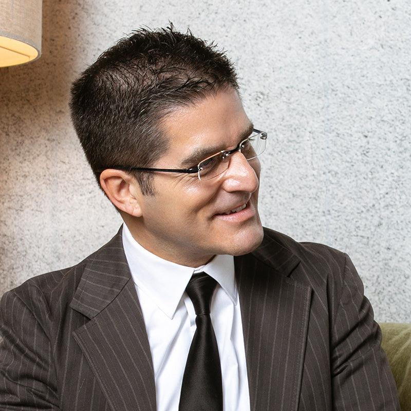 Man wearing black lightweight rimless reading glasses