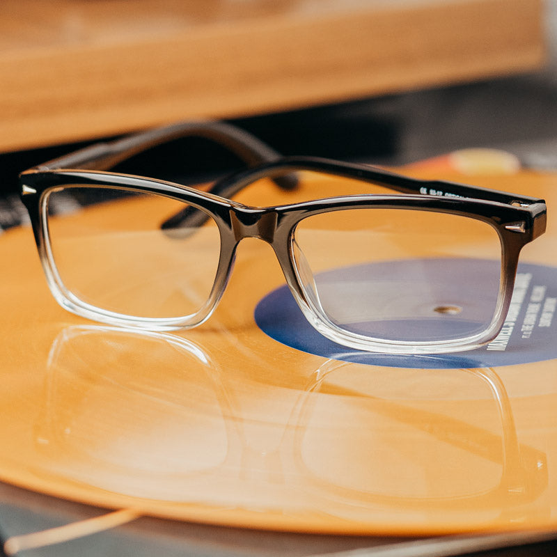 The Beau Lightweight Designer Progressive Reading Glasses Sitting On An Album