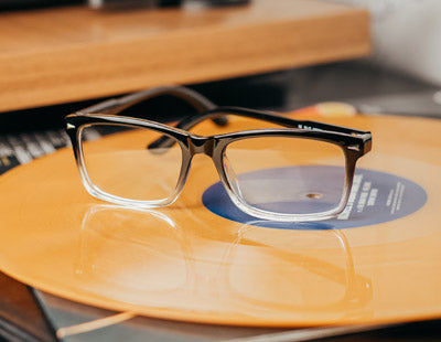 Visualites Beau classic reading glasses sitting on a vinyl record