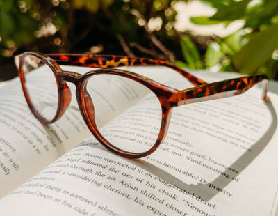 Quality tortoise shell reading glasses sitting on a book