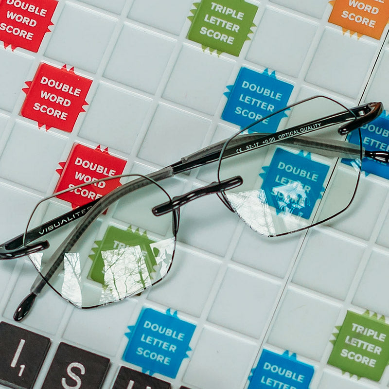 Visualites Adore Blue Light Filtering Quality Reading Glasses For Women n Black Sitting On A Scrabble Board