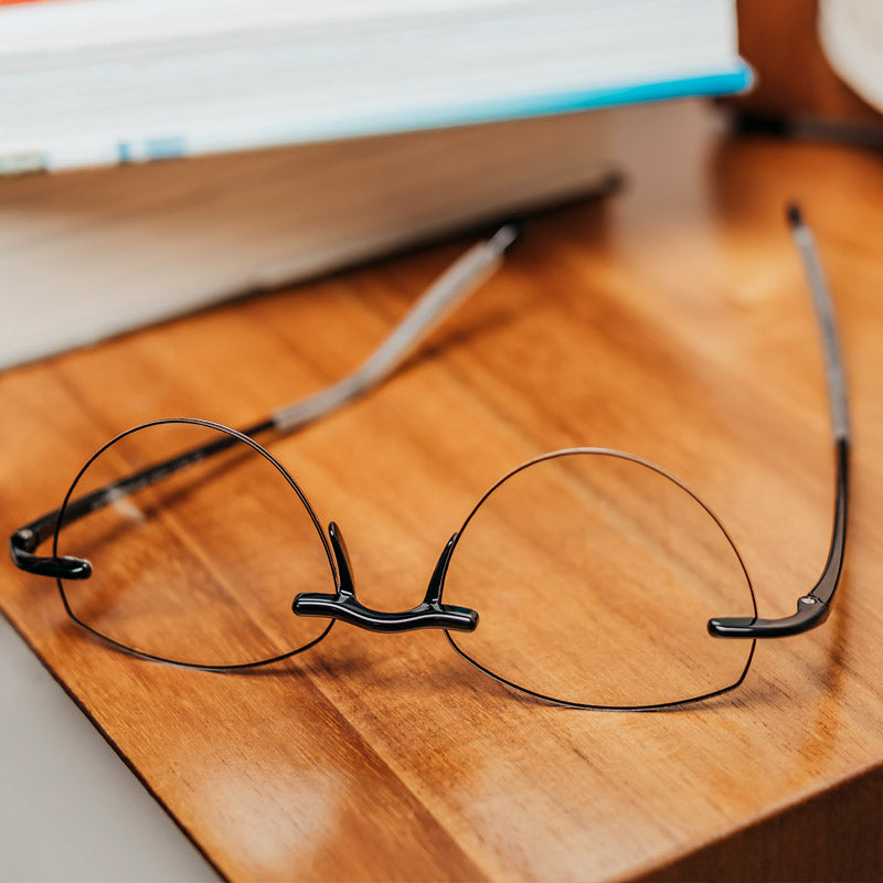 Visualites Amour Rimless Reading Glasses With Progressive Lenses On A Nightstand