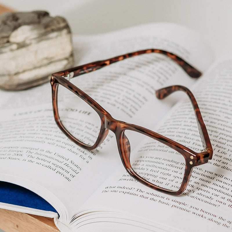 The Beau Quality Progressive Reading Glasses Sitting On A Book