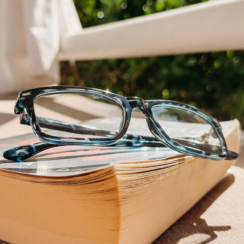 The Beau Durable Progressive Reading Glasses Sitting On A Book